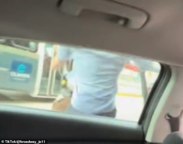 The officer throws the driver against the window of his own car before handcuffing him