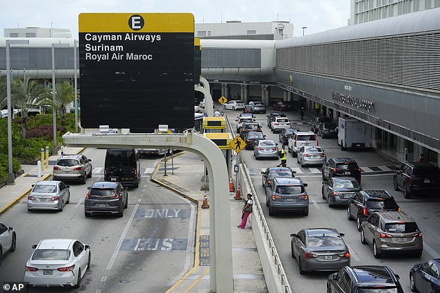 Vehicles drive through the departure hall at Miami International Airport on July 3, 2024.