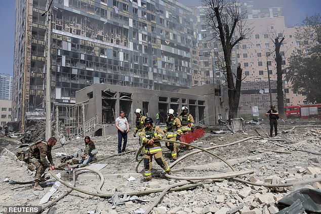 Rescue workers work at the site of a building damaged by a Russian missile attack, during the Russian attack on Ukraine, in Kiev, Ukraine, July 8, 2024