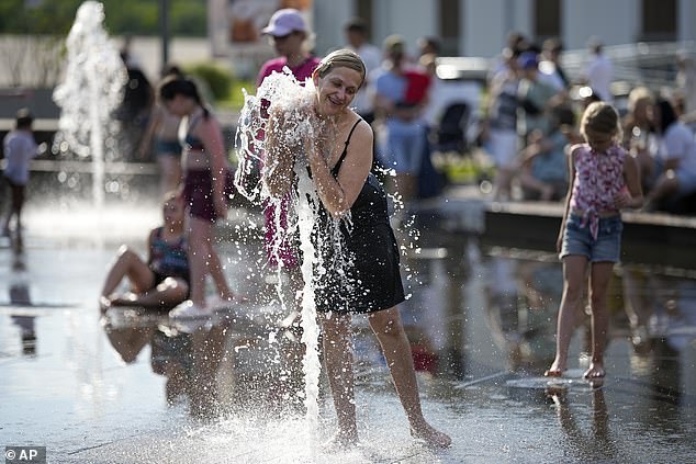 June marks the 13th consecutive month of record-breaking global temperatures. Here, a woman cools off in a fountain in Moscow, Russia, June 30, 2024