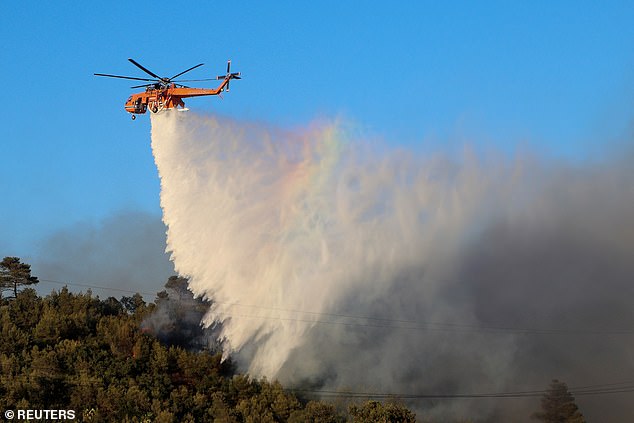 Long periods of hot, dry weather and a lack of rain make forest fires more likely. Pictured, a firefighting helicopter drops water as a forest fire rages in Stamata, near Athens, Greece, June 30, 2024