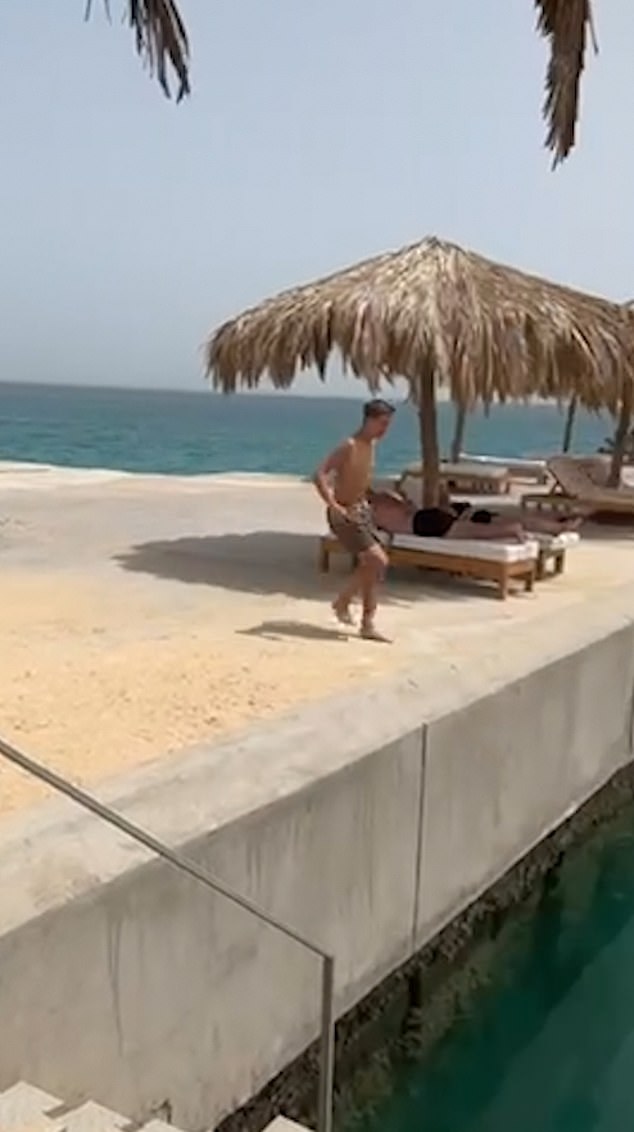 Video footage from his holiday in Egypt in September shows him laughing and making the same motion from the side of a pier