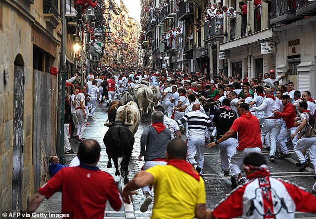 Participants run for "Beef Goat" bulls during the "turning back" (bull run) of the San Fermin festival in Pamplona, ​​​​northern Spain, on July 8, 2024