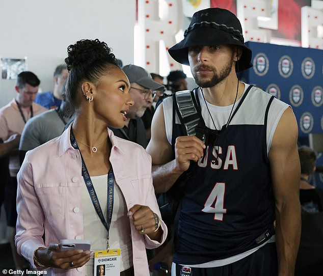 Malika Andrews (left) talks to Stephen Curry as he leaves a press conference after a workout