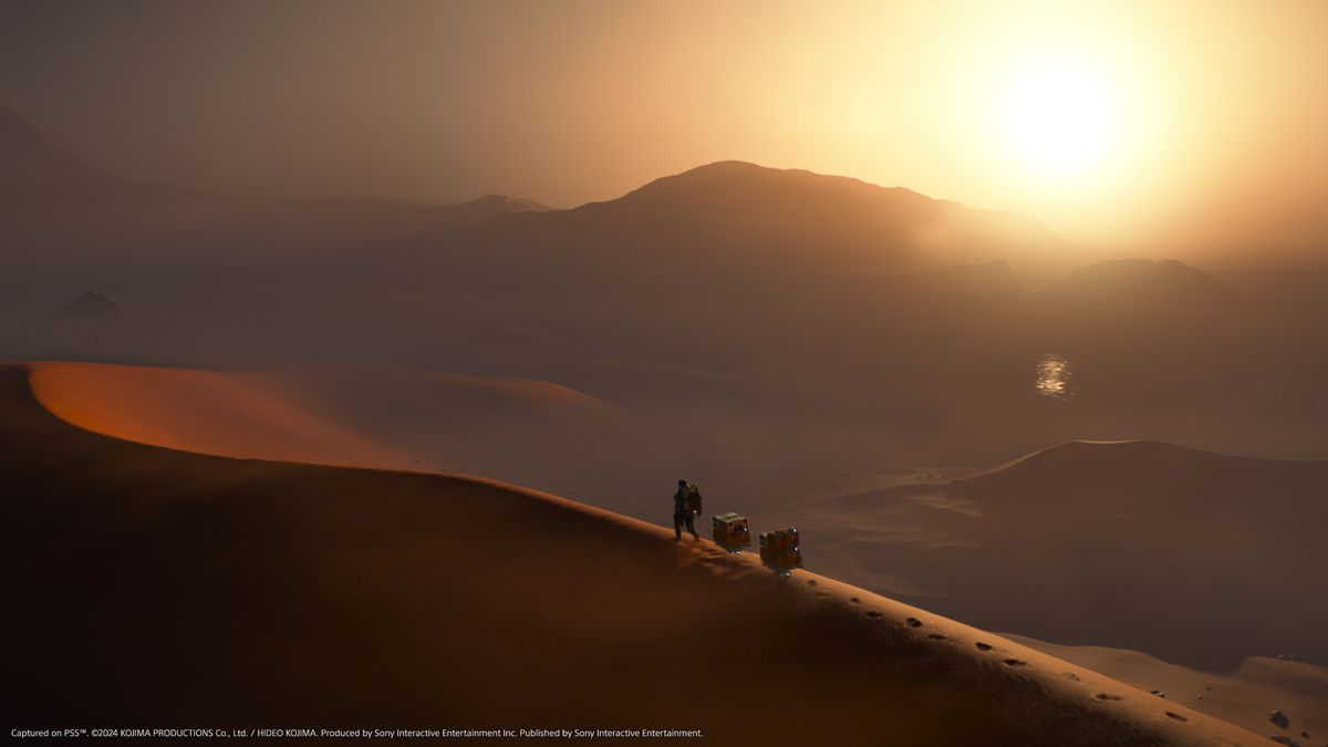 A wide shot of Sam Bridges walking across the top of a desert dune in Death Stranding 2