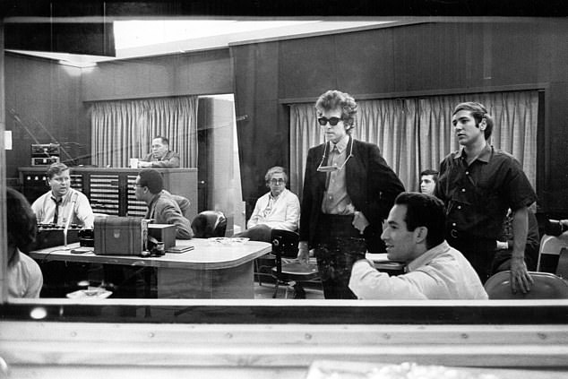 Her most famous act in the music world was introducing Bob Dylan to the Hawks, who would later become The Band. The folk icon is seen here with Martin's old boss Albert Grossman in 1965 during construction work for Highway 61 Revisited