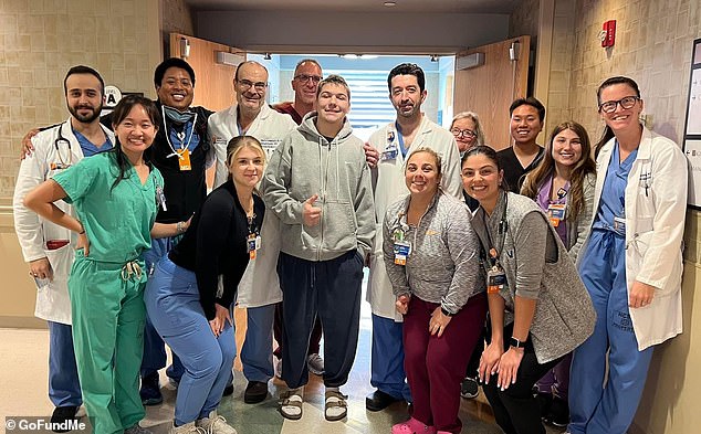 His wrestling career remains somewhat uncertain, though some doctors who worked on him remain optimistic. He poses with the medical team that saved his life