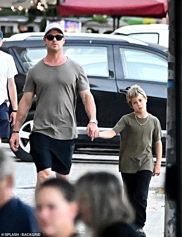 Chris looked casually dressed in a gray T-shirt paired with black shorts and Nike sneakers