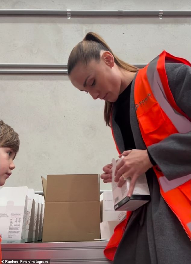 The siblings wore reflective clothing as they carefully stacked the supplements into cardboard boxes while their mother supervised.