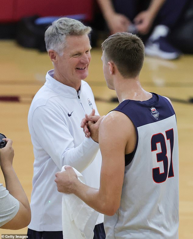 Flagg (31) shakes hands with USA Basketball head coach Steve Kerr after practice