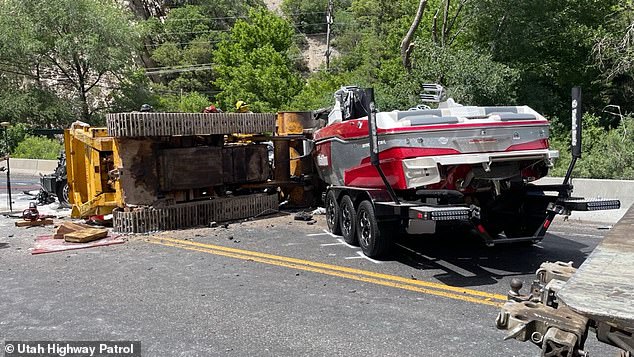 A tow truck hauling a bulldozer was coming from the opposite direction on the narrow two-lane road when the machine tipped over from behind, directly hitting the SUV