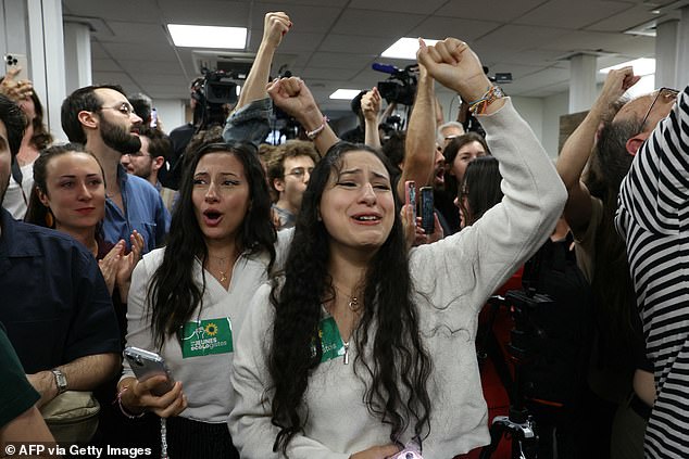 Supporters of the green party The Ecologists-EELV celebrate the first results of the second round of the French parliamentary elections during the party's election night event in Paris on Sunday