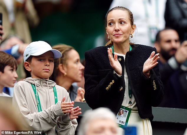 His wife Jelena Djokovic (right) looked slightly uncomfortable as Djokovic attacked the crowd