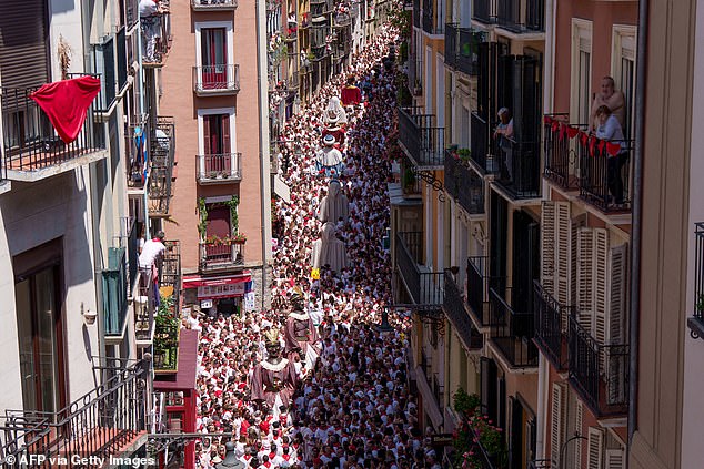 Partygoers attend the parade of "Giants and Cabezudos" (Giants and big head puppets) as part of the San Fermin festival in Pamplona on Sunday