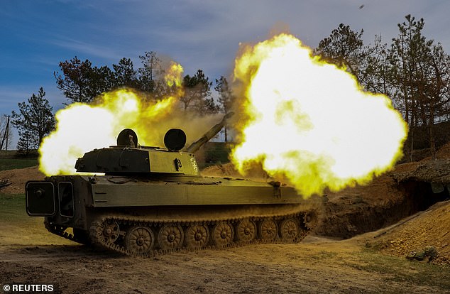 Ukrainian soldiers from the 37th Marine Brigade fire a 2S1 Gvozdika self-propelled howitzer at Russian troops