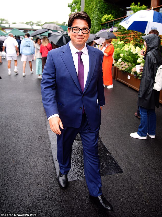 Michael McIntyre looked stylish for the occasion in a navy suit and white shirt