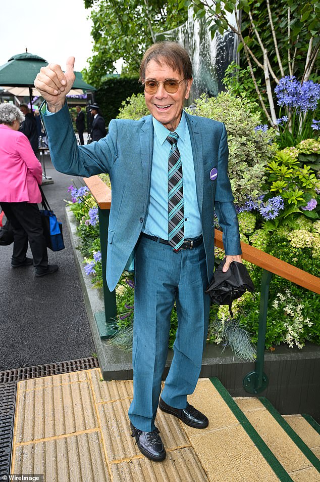 Cliff Richard gave a thumbs up as he arrived in a teal suit