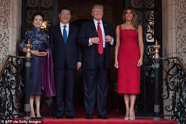 Melania wore a red Valentino dress she originally wore in April 2017 when she and then-President Trump hosted Chinese President Xi Jinping (2nd from left) and his wife Peng Liyuan (left) at Mar-a-Lago