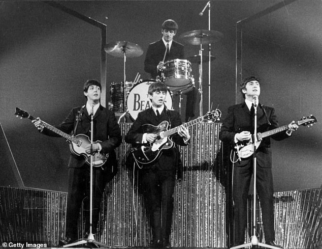 The Beatles on stage at the London Palladium performing to 2,000 screaming fans