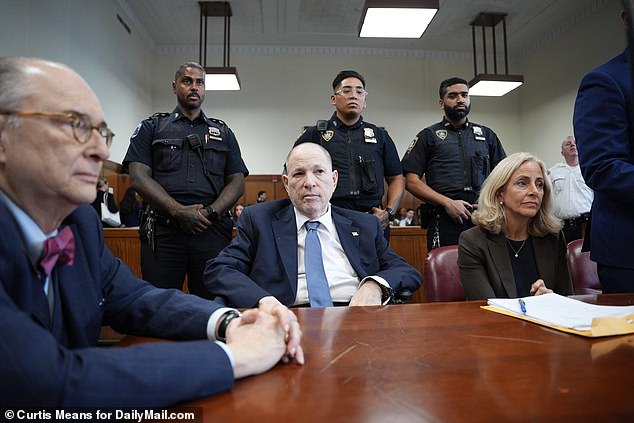 Weinstein is flanked by his team of lawyers in Manhattan court this morning