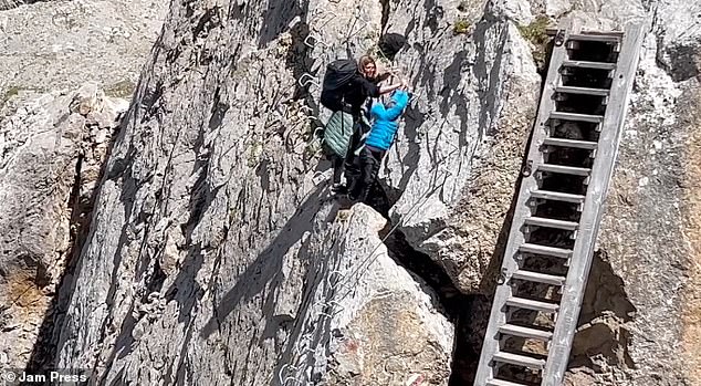 Another video shows a young child reaching out to reach the handholds on the path