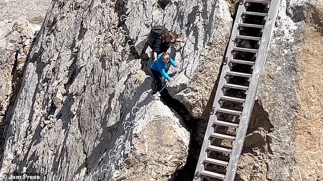 The foreign tourists were climbing in the Italian Dolomites when they were captured on camera