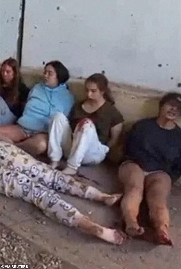 Israeli soldiers Liri Albag, Agam Berger, Daniela Gilboa and Naama Levy sit on the ground during their capture by Hamas soldiers at the Nahal Oz military base in southern Israel on October 7, 2023, in this screenshot from a video released on May 22, 2024.