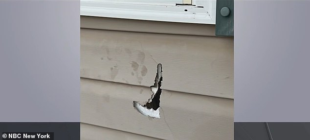 A hole was left in a house with a piece of metal from the explosive torn through it