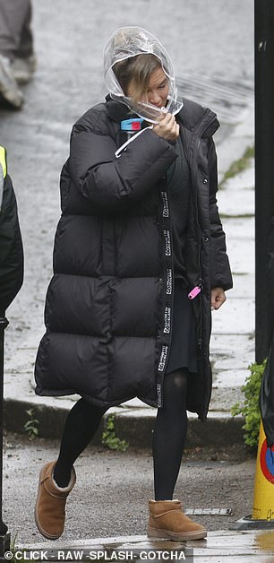 Renee was forced to wear a hair-protecting hood and a black puffer jacket as she braved the bad weather on set in Hampstead