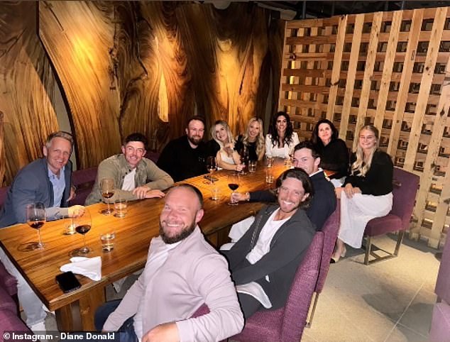 McIlroy (second from back left) and Erica Stoll (fourth from back right) enjoyed a night out with his Ryder Cup teammates and their partners in London on Sunday evening