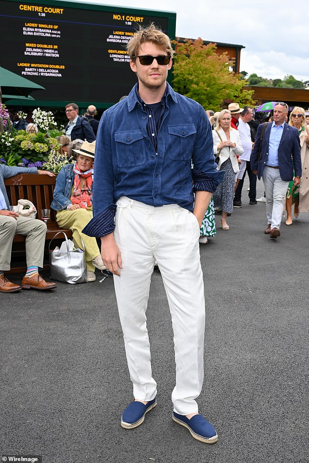 Joe Alwyn looked handsome in a blue Ralph Lauren shirt and white chinos