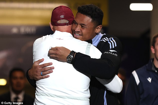 New Zealand's Calen Clarke, right, hugs Strawbridge, who worked as a skills coach with the All Blacks during their run to the Rugby World Cup final last year