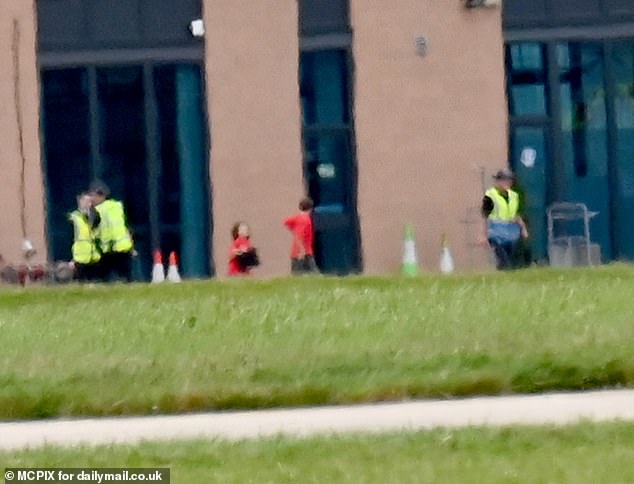 She dressed casually in a white hoodie as she drove across the tarmac before flying into the grey English clouds, her children following her