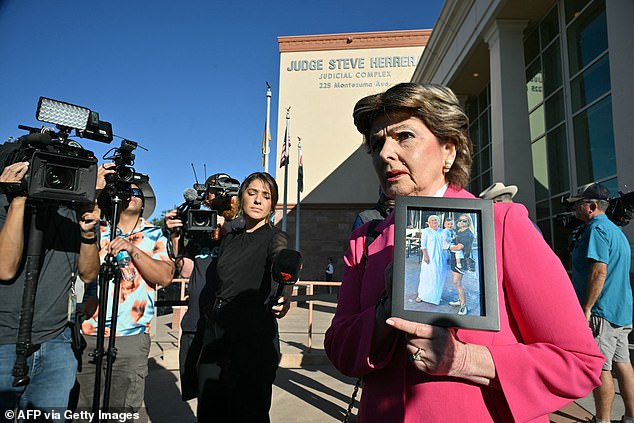 Outside the court, attorney Gloria Allred was present, holding a photo of Halyna Hutchins, her mother Olga and Hutchins' son and calling Baldwin 