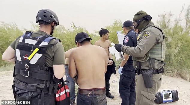 Shirtless migrants, who had been wading through the waters of the Rio Grande for more than 3 hours, were rescued by dive teams and turned over to the U.S. Border Patrol