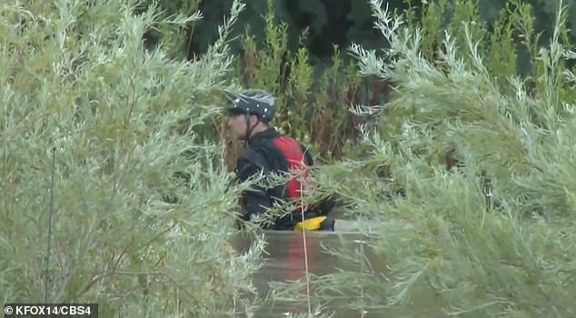 A U.S. law enforcement diver enters the Rio Grande Tuesday afternoon to rescue migrants from certain drowning in the Rio Grande