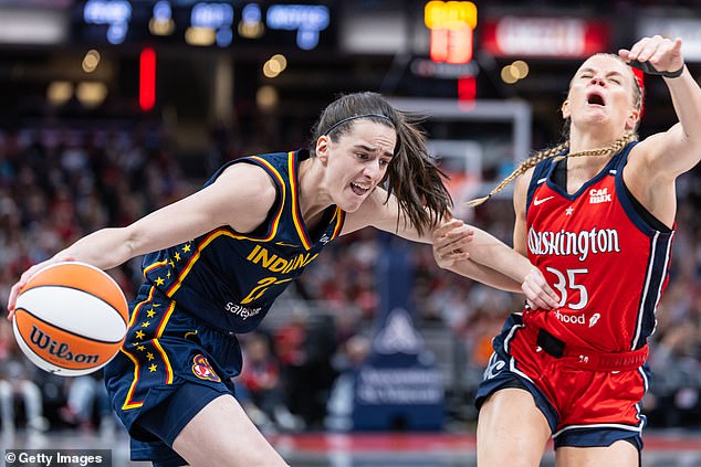 Caitlin Clark of the Indiana Fever dribbles against Julie Vanloo of the Washington Mystics