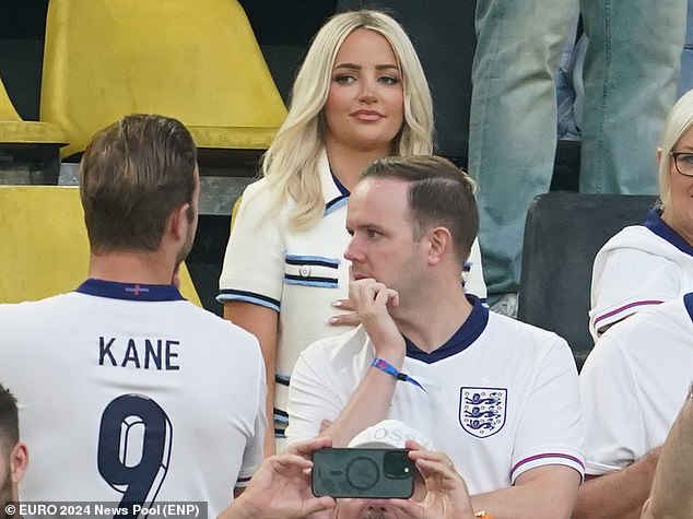 Wearing an English top, paired with a glamorous white and blue blazer and skirt, Megan looked more than ready to support her goalkeeper husband