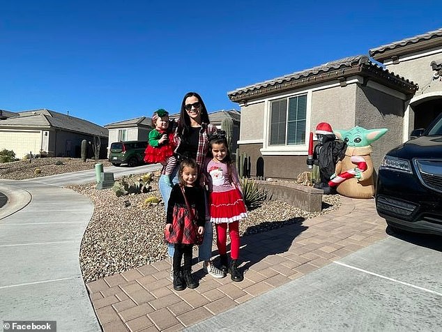 Parker with her mother Erika and her two sisters in front of their Tucson home on Halloween, just yards from where she died