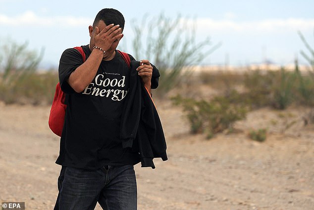 A migrant walks through the Chihuahuan Desert in Ciudad Juarez, Mexico