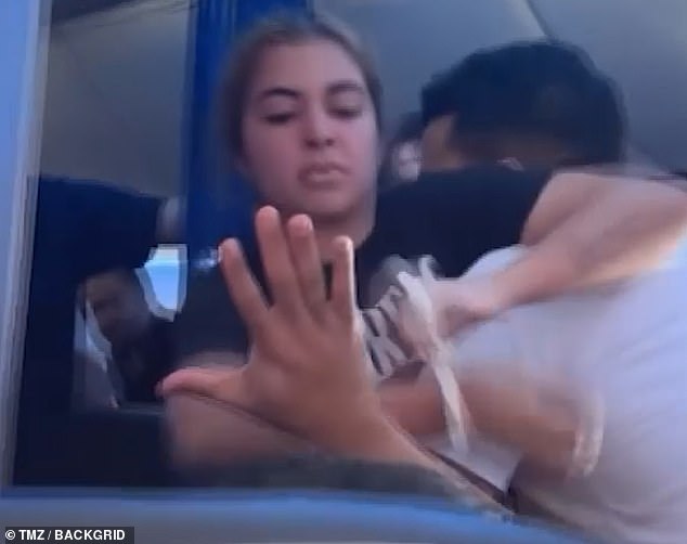 Video recorded by another passenger began after crew bound her wrists with cable ties and she struggled with three of them