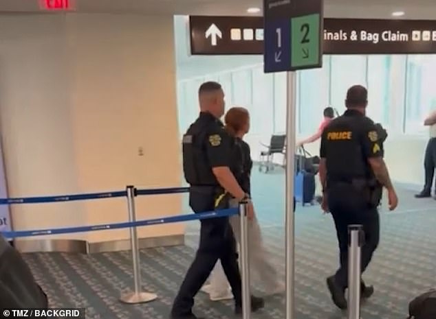 More videos from after the plane landed in Orlando showed the woman being led out of the airport by police