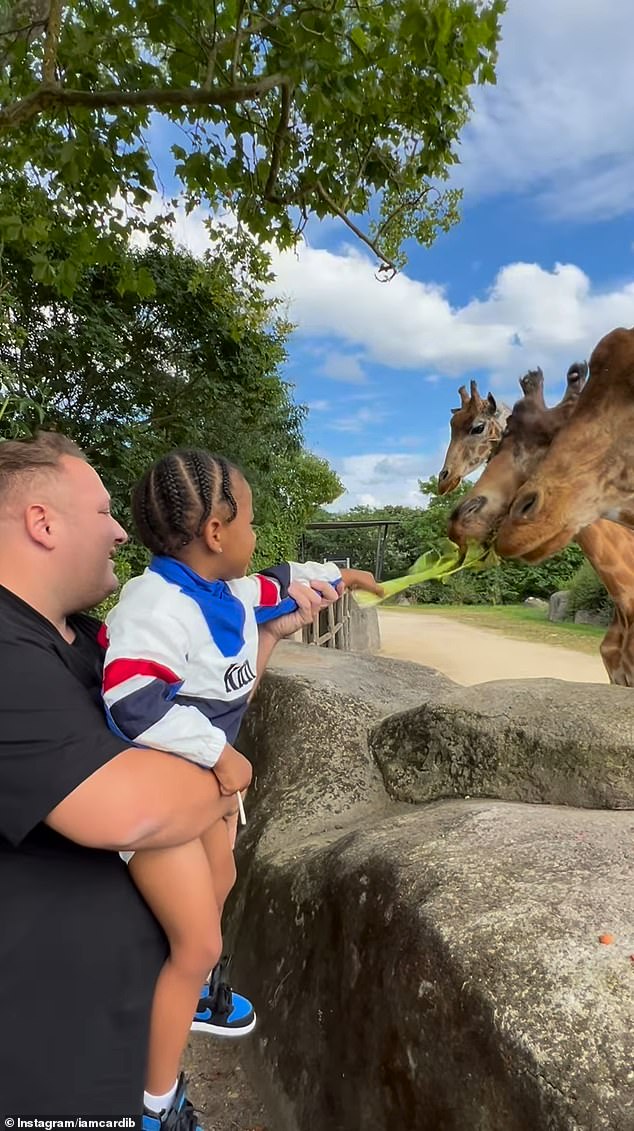 Cardi filmed her son feeding giraffes at the Paris Zoo