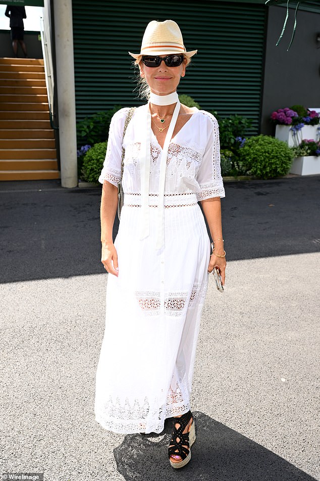 Dawn McDaniel exuded summer style in a white dress with a scarf and straw hat