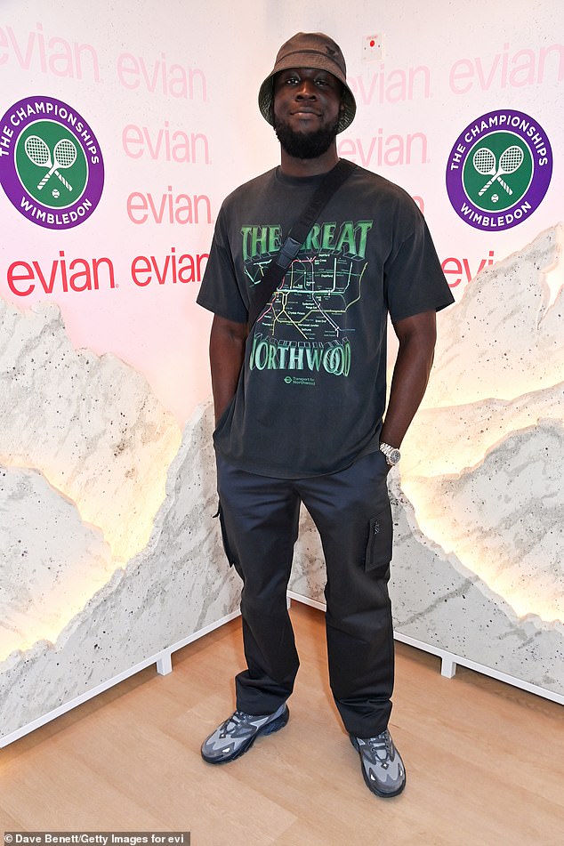 The British rapper, 30, looked fresh in a gray logo T-shirt and pants combo, completing the look with a bucket hat and pants