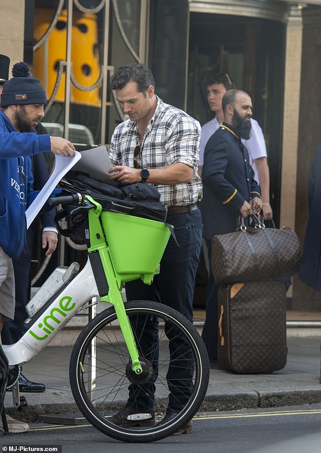 Meanwhile, Henry was seen outside the hotel with a man and was seen signing some paper