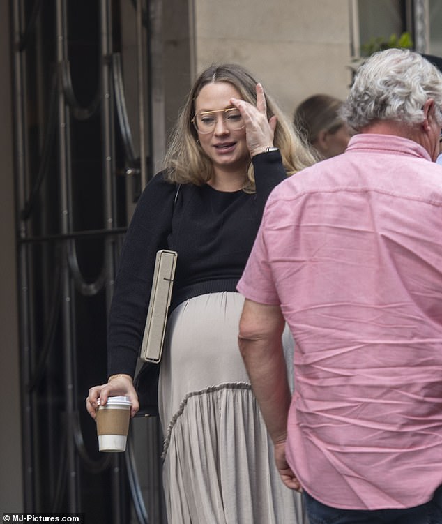 Natalie kept her makeup to a minimum and wore oversized glasses