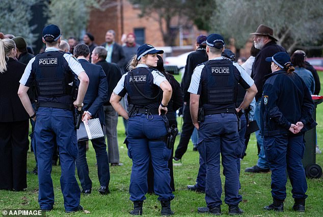 Local police officers hold a neighbourhood watch on Thursday for the three young children who died in a house fire in Lalor Park on Sunday