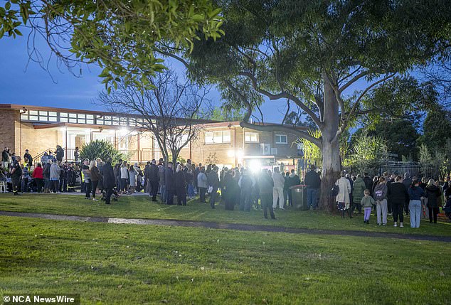 Members of the Lalor Park community gather in Chifley Park on Thursday for a vigil in memory of the three young children who died in a house fire on Sunday