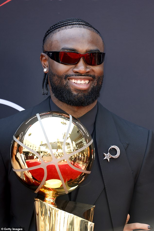 Brown hit the red carpet in Los Angeles holding the Larry O'Brien trophy